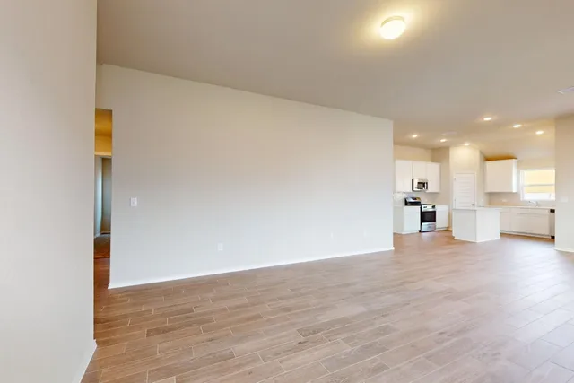 a view of a kitchen with a sink and a refrigerator