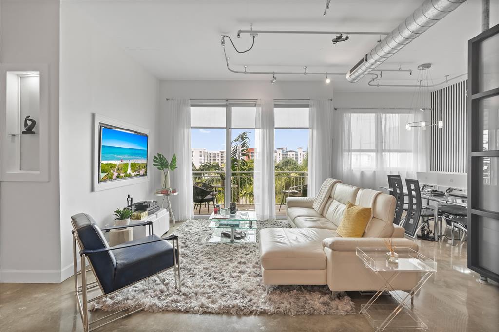 313 Northeast 2nd Street, Unit 405 Fort Lauderdale, FL 33301 - Photo 17 of 49 a living room with furniture and a large window