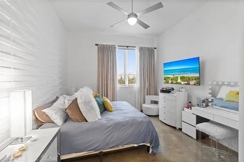 a bedroom with a bed and a lamp