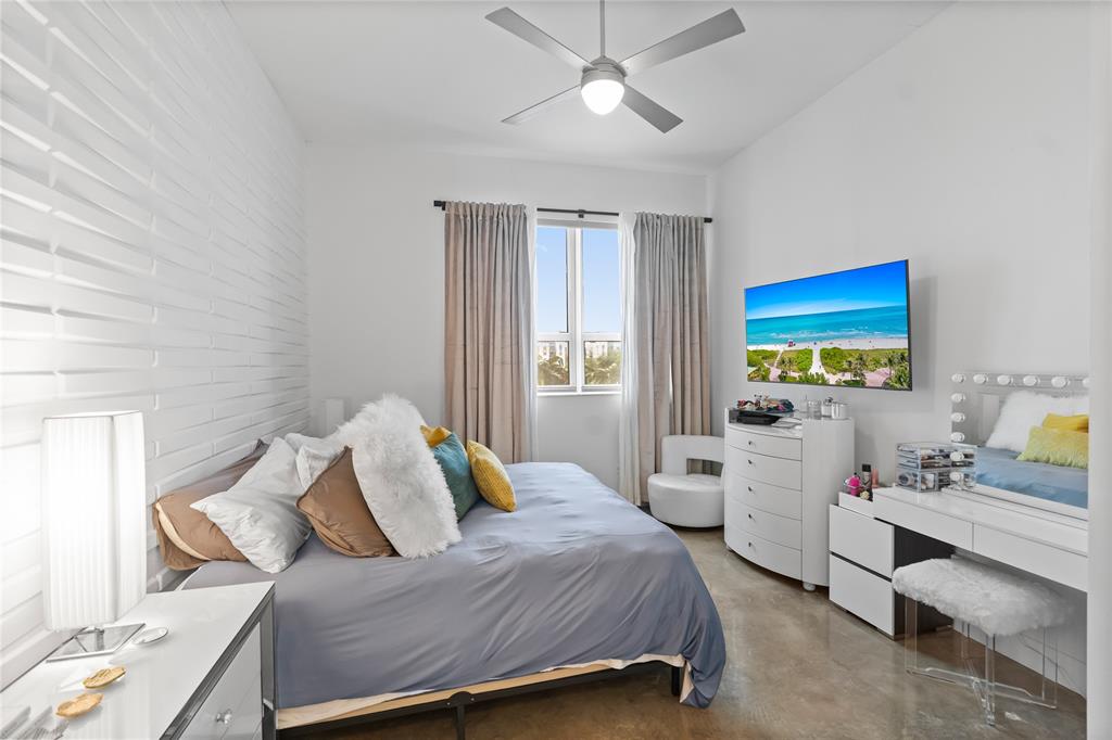 313 Northeast 2nd Street, Unit 405 Fort Lauderdale, FL 33301 - Photo 19 of 49 a bedroom with a bed and a chandelier