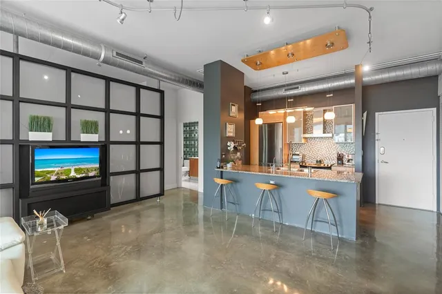 a view of balcony with two chairs and a potted plant