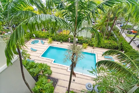 a balcony with table and chairs