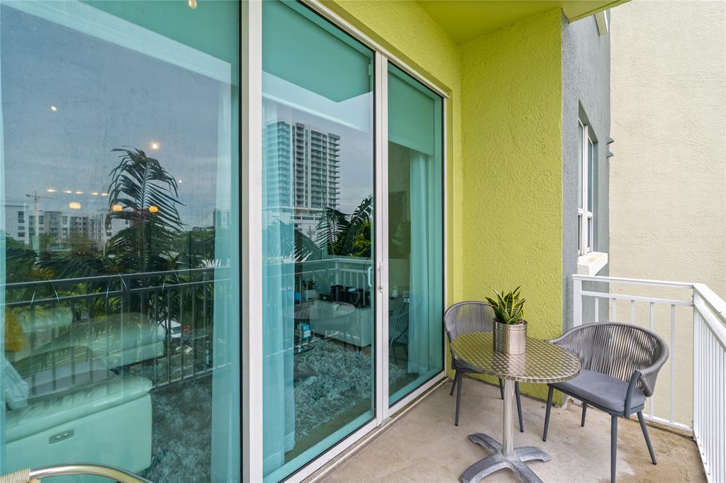 313 Northeast 2nd Street, Unit 405 Fort Lauderdale, FL 33301 - Photo 31 of 49 a balcony with table and chairs