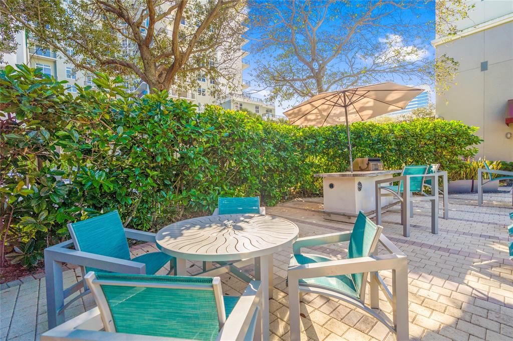 313 Northeast 2nd Street, Unit 405 Fort Lauderdale, FL 33301 - Photo 42 of 49 a view of a table and chairs in patio