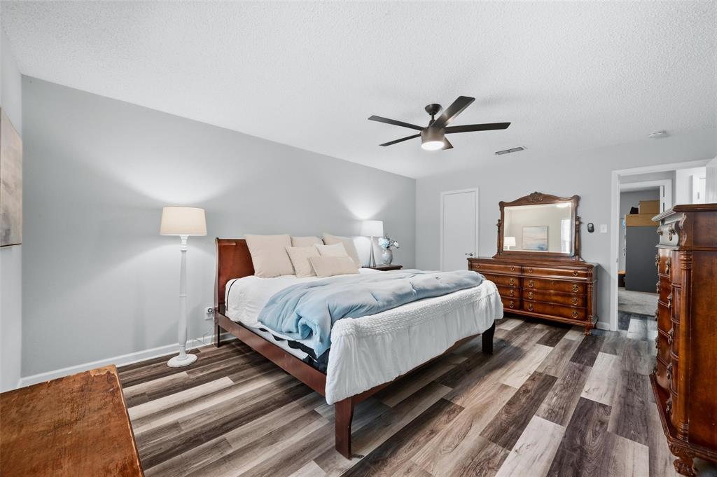 608 Ridgewood Circle Hurst, TX 76054 - Photo 23 of 38 Spacious room featuring wood-finish flooring, light gray wall paint, and a ceiling fan with integrated lighting