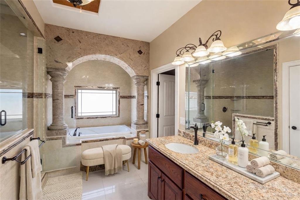 1339N North FM 649 Rio Grande City, TX 78582 - Photo 14 of 37 a bathroom with a granite countertop sink a mirror and a bathtub