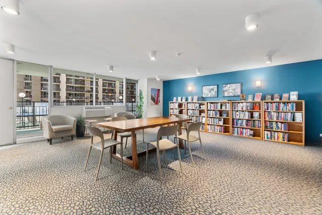 a living room with furniture and a red lamp