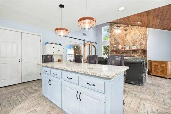 a kitchen with cabinets and window