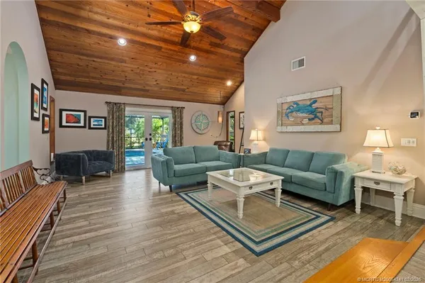 a living room with furniture a rug and a large window