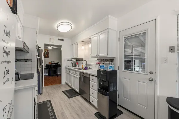 a kitchen with stainless steel appliances kitchen island granite countertop a refrigerator and a stove top oven