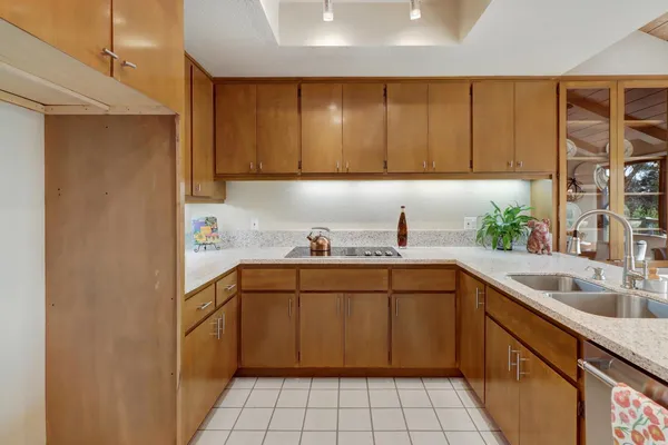 a kitchen with a sink cabinets and window