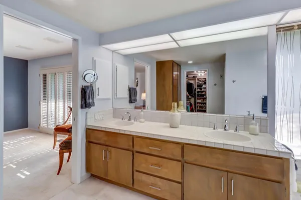 a bathroom with a double vanity sink and a mirror
