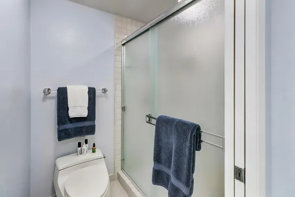 a bathroom with a toilet and a mirror