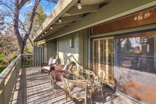 a view of balcony with wooden floor and fence