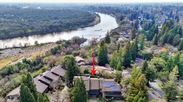 an aerial view of a house with a yard and garden