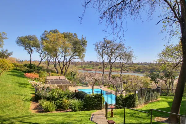 a view of a house with a yard and sitting area