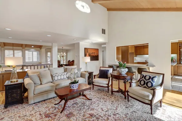 a living room with furniture a rug and a lamp