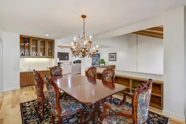 a view of a dining room with furniture and chandelier