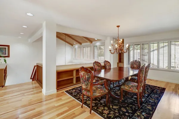 a view of a dining room with furniture and wooden floor
