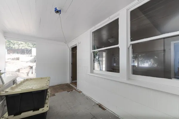 a view of workspace with wooden floor and windows