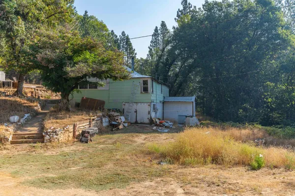 a backyard of a house with table and chairs