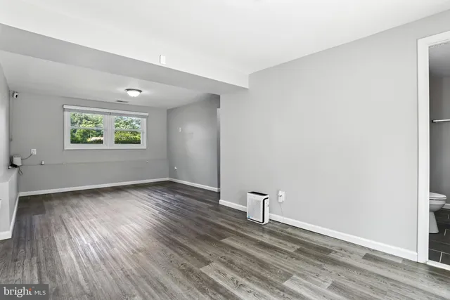 a living room with furniture a rug and a large window