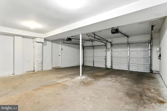 a view of a white house with a yard and garage
