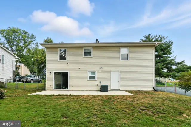 a view of a house with swimming pool and sitting area