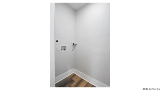 a kitchen with a sink a counter top space and living room view