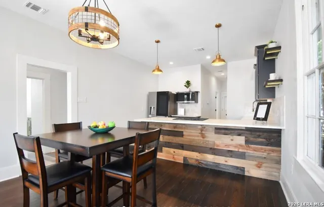 a kitchen with a table and chairs in it