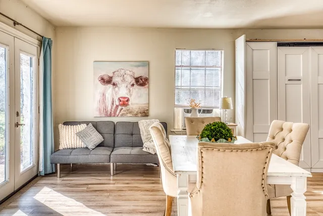 a living room with furniture and large windows