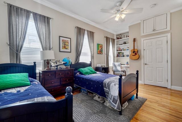 a bedroom with a bed window and a table