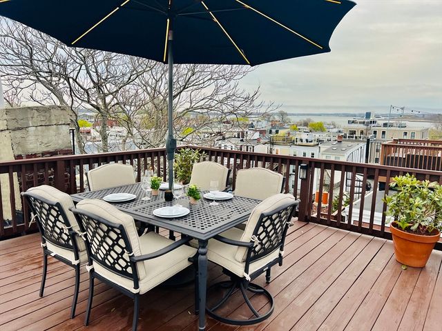 a terrace with outdoor seating and wooden floor