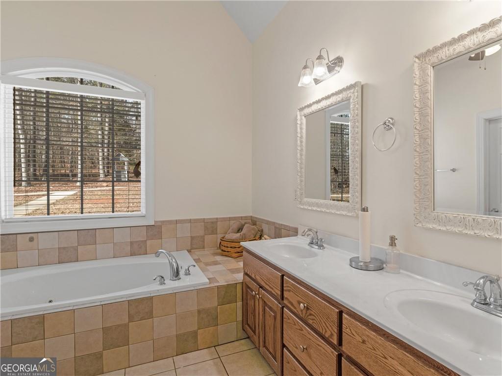 355 Parker Road Covington, GA 30014 - Photo 48 of 60 a bathroom with a tub sink and mirror