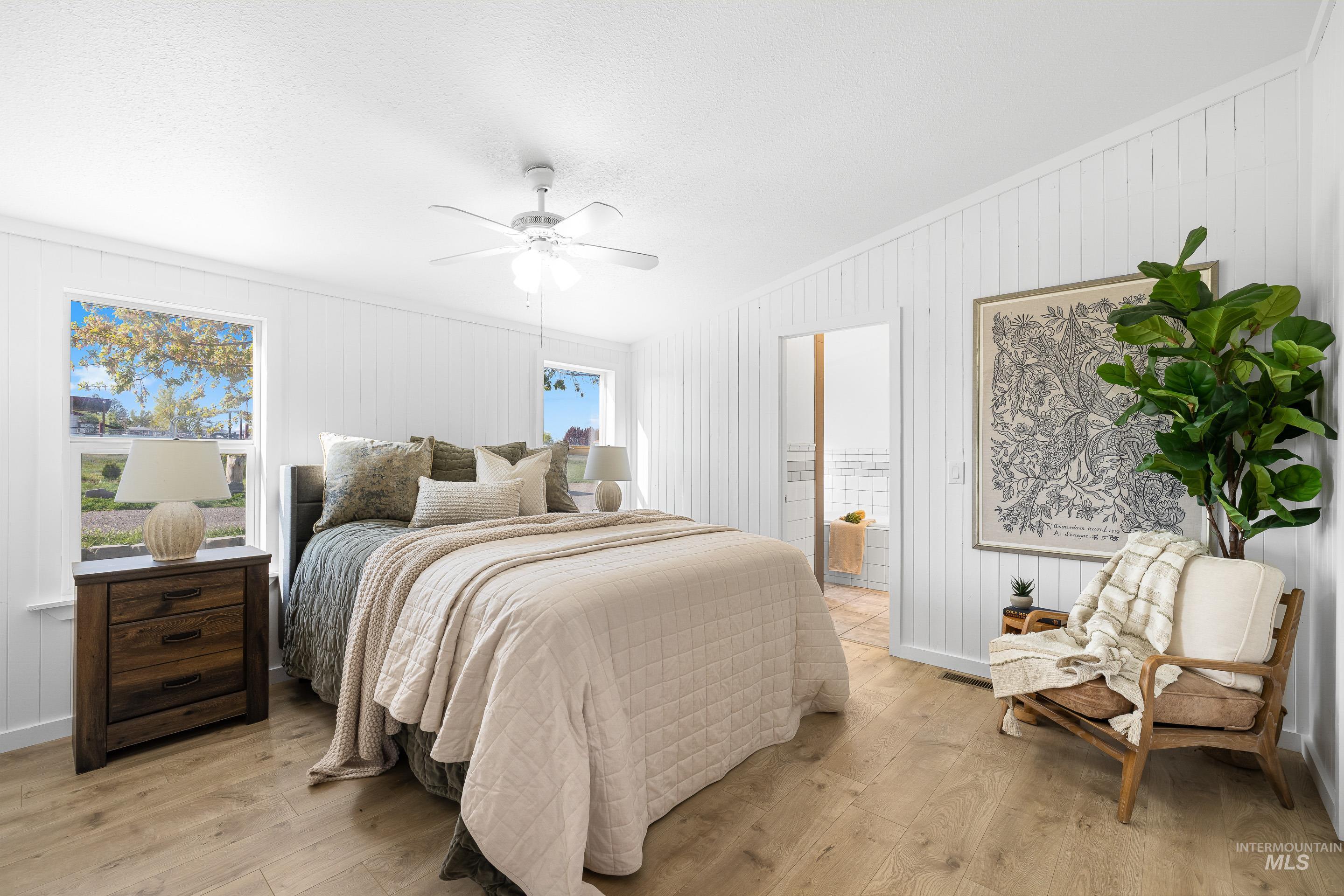 2427 Northside Road Homedale, ID 83628 - Photo 16 of 49 Bedroom featuring light wood-type flooring, ensuite bath, and ceiling fan