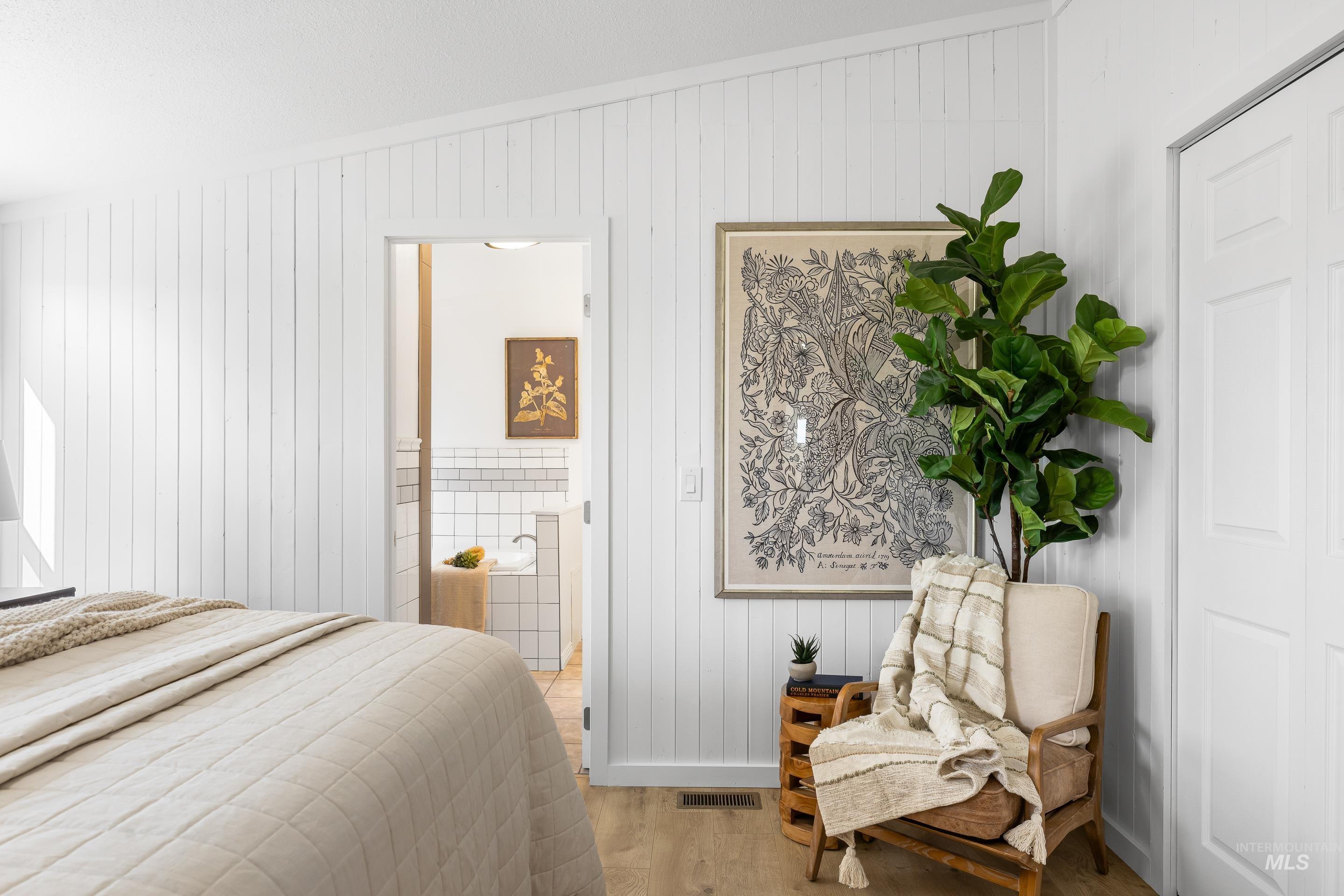 2427 Northside Road Homedale, ID 83628 - Photo 17 of 49 Bedroom featuring light wood finished floors, vaulted ceiling, and wooden walls
