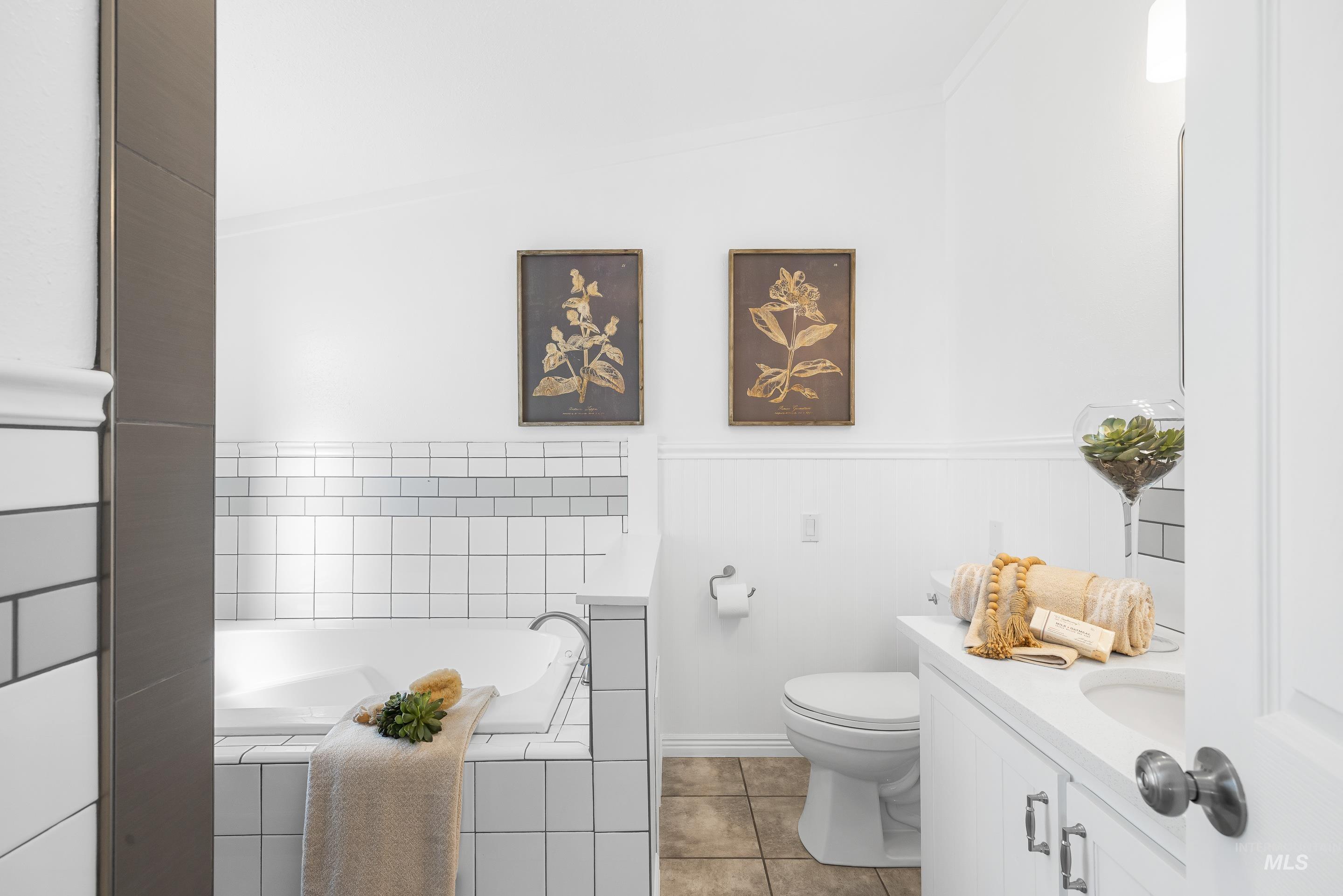 2427 Northside Road Homedale, ID 83628 - Photo 18 of 49 Full bathroom featuring a garden tub, vanity, light tile patterned floors, and crown molding