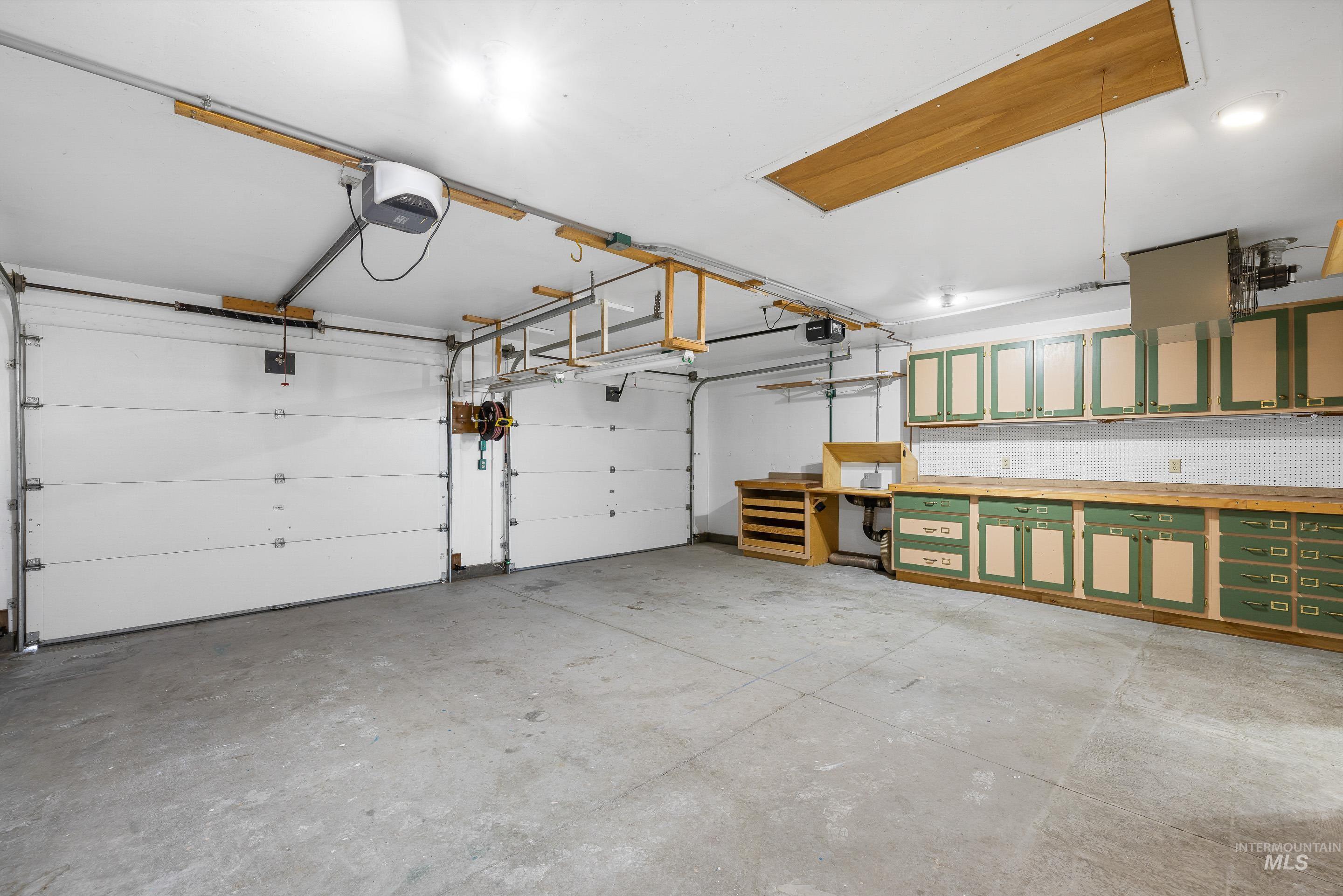 2427 Northside Road Homedale, ID 83628 - Photo 25 of 49 Garage featuring a garage door opener and a heating unit