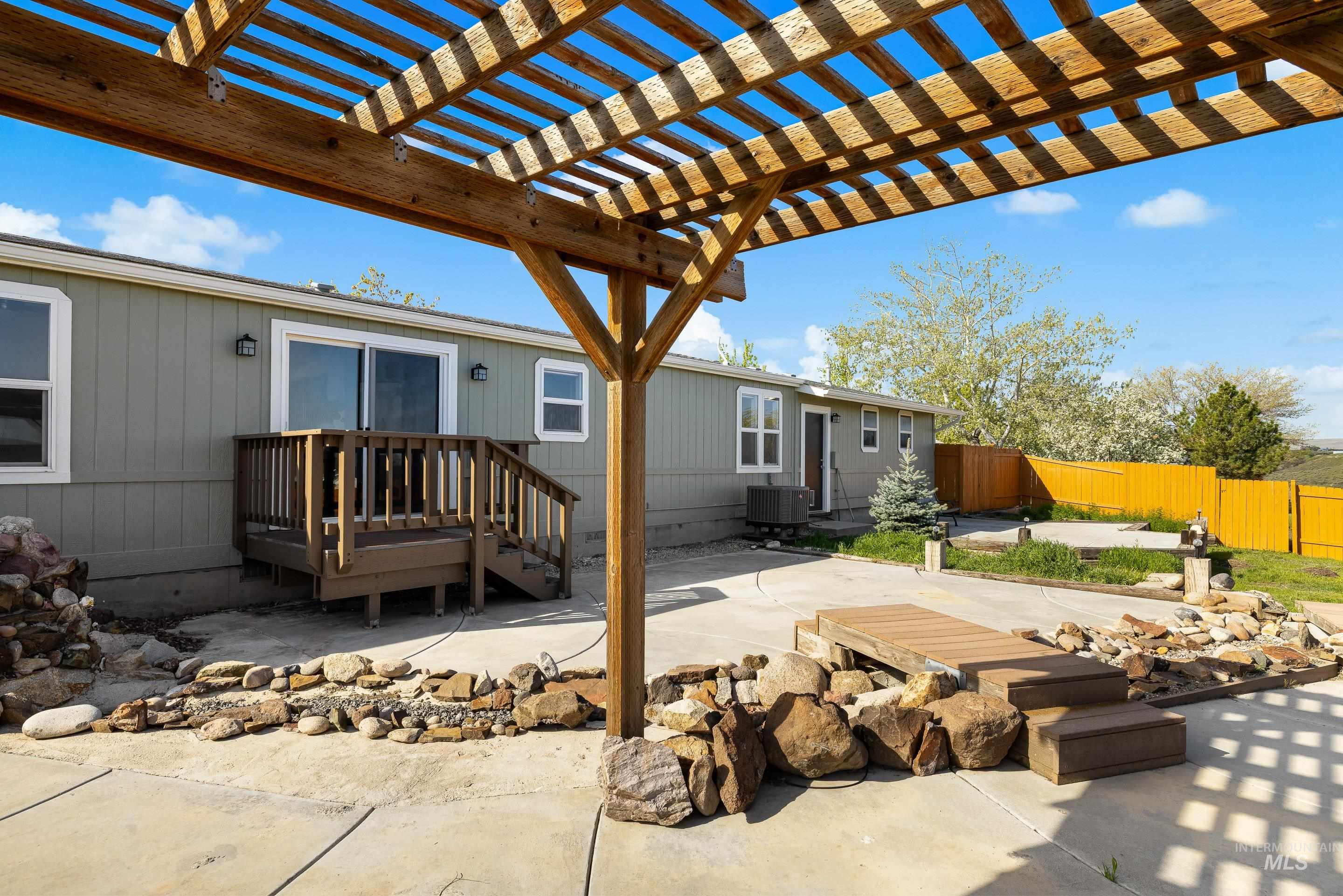 2427 Northside Road Homedale, ID 83628 - Photo 36 of 49 Fenced backyard featuring a patio, a pergola, and a deck