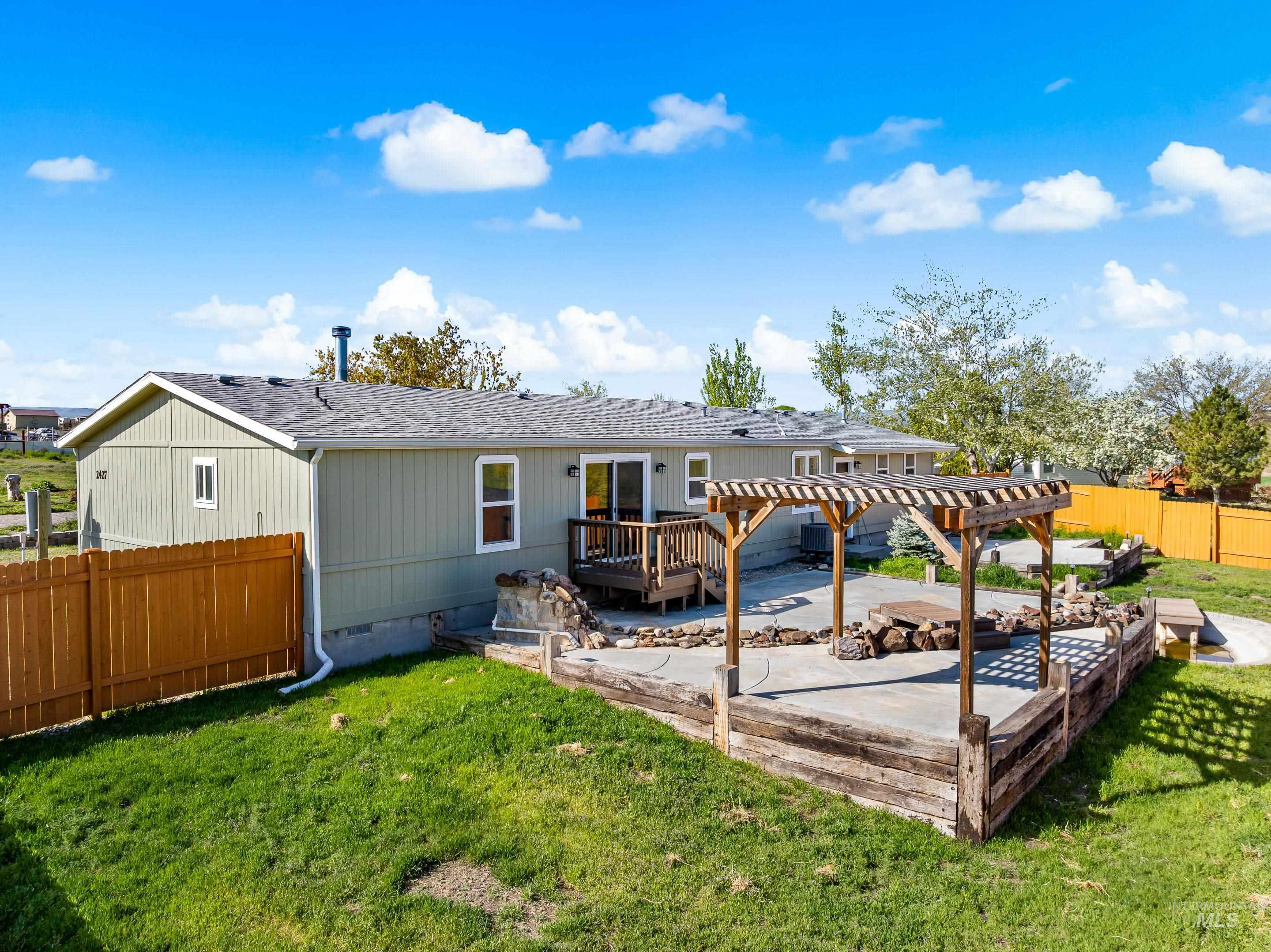 2427 Northside Road Homedale, ID 83628 - Photo 39 of 49 Rear view of house with roof with shingles, a fenced backyard, crawl space, a patio, and a wooden deck