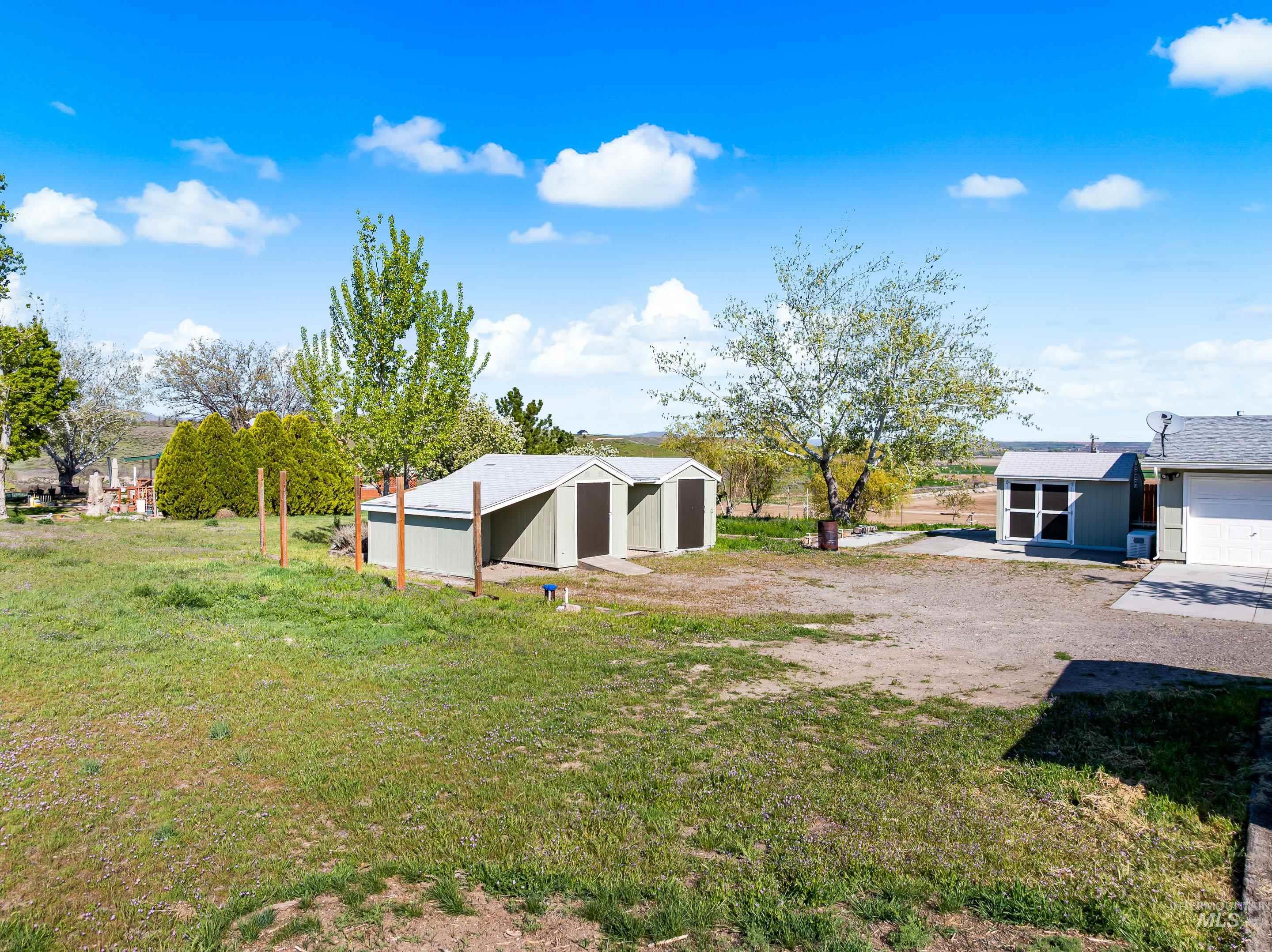 2427 Northside Road Homedale, ID 83628 - Photo 48 of 49 View of green lawn with an outdoor structure, an outbuilding, and driveway