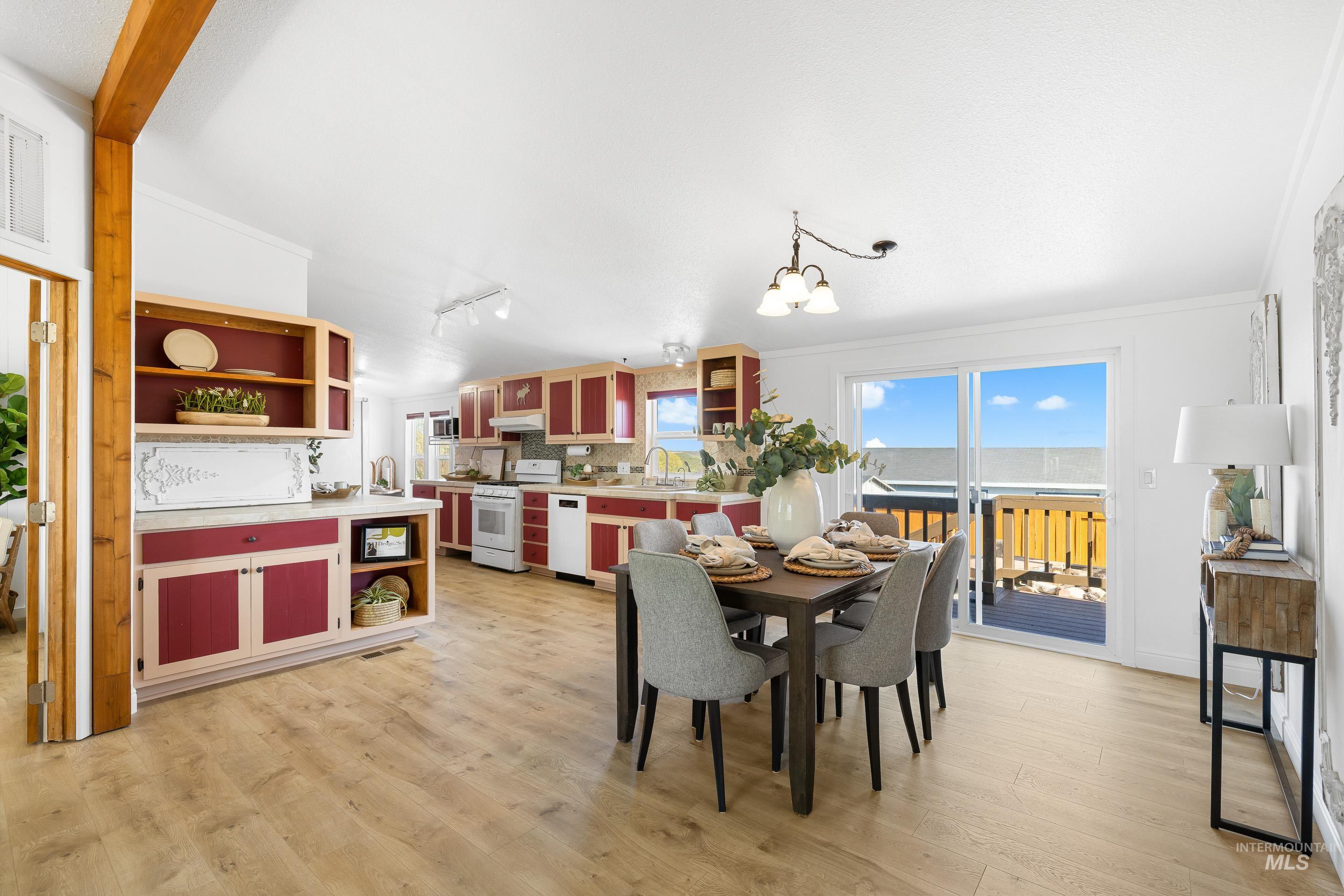 2427 Northside Road Homedale, ID 83628 - Photo 8 of 49 Dining space featuring light wood finished floors, lofted ceiling, and a chandelier