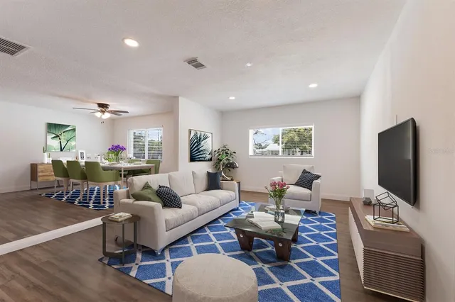 a living room with furniture a rug and a flat screen tv