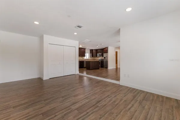 a view of a room with wooden floor and window
