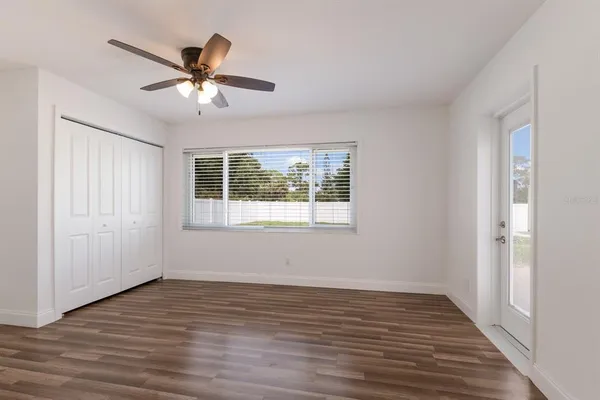 a view of a livingroom with a window and wooden floor