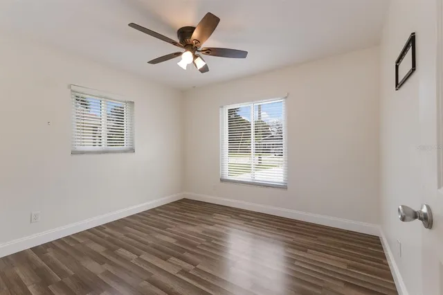 a view of a livingroom with wooden floor and a window