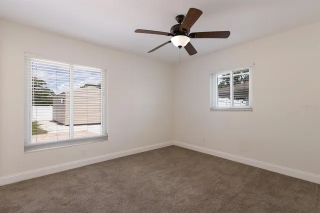 a view of a livingroom with a ceiling fan and window