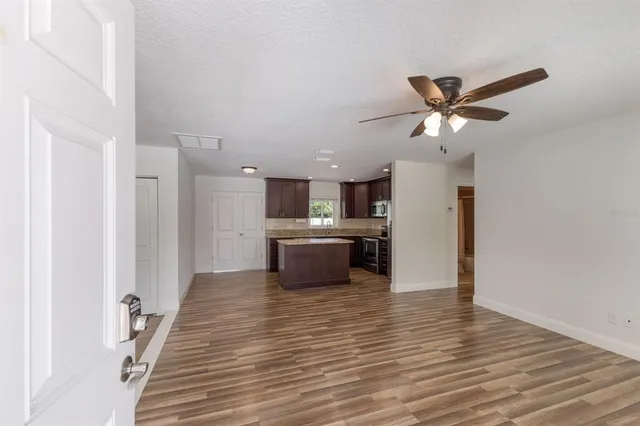 a view of a kitchen with a sink and a refrigerator