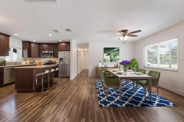 a view of a dining room with furniture window and wooden floor