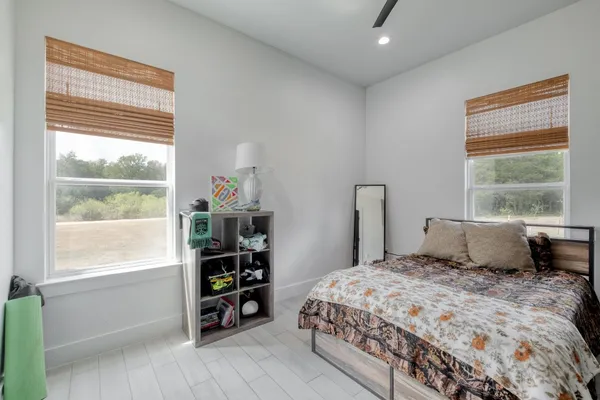 a bedroom with a large bed and a window